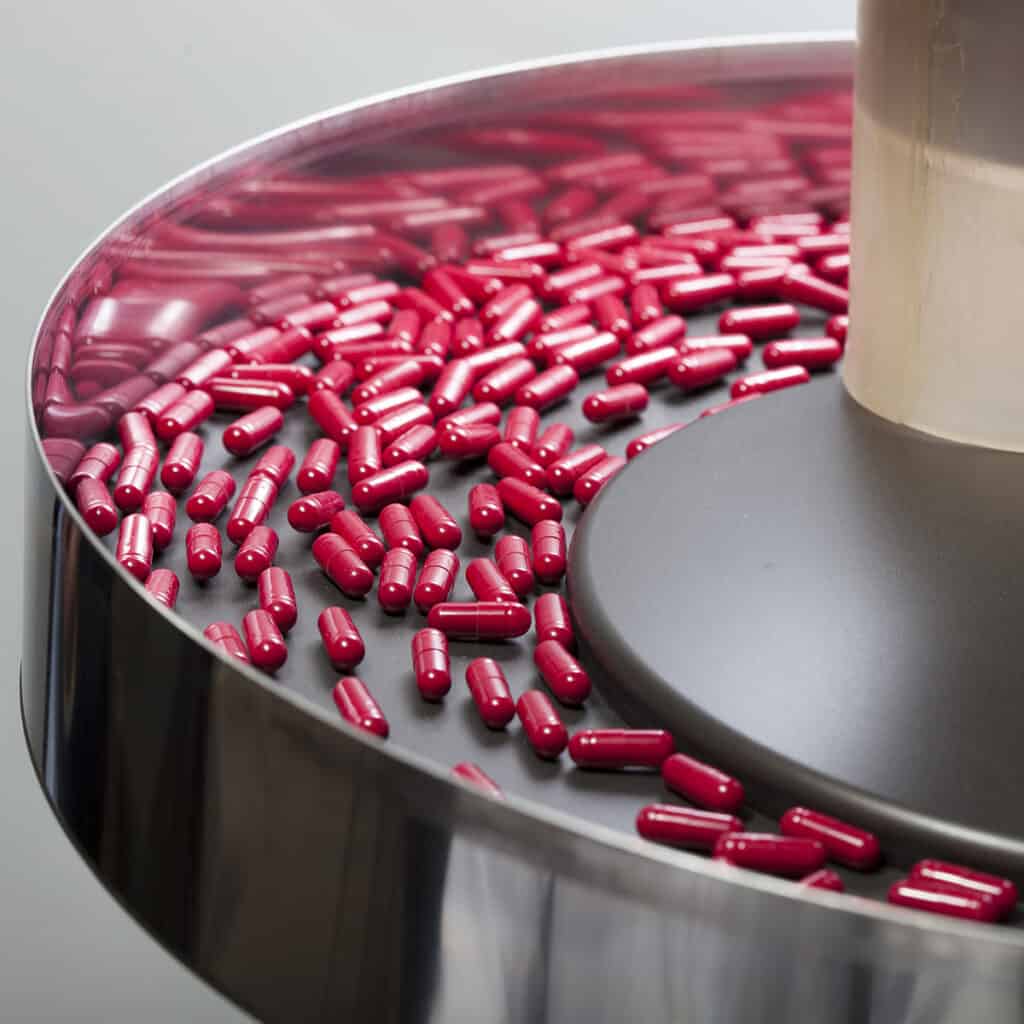 red pills on a pharmaceutical production line