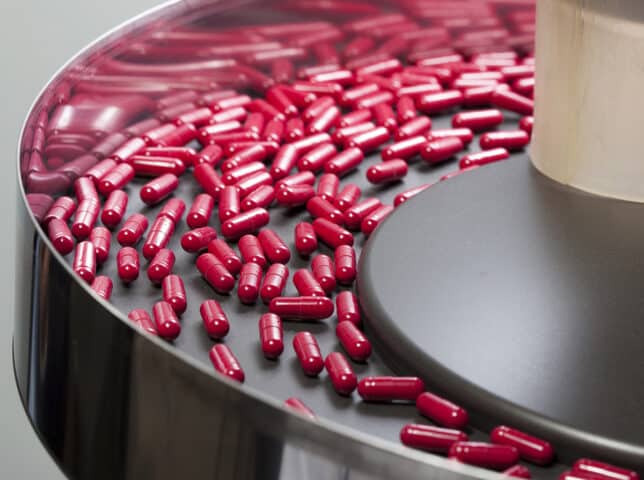red pills on a pharmaceutical production line
