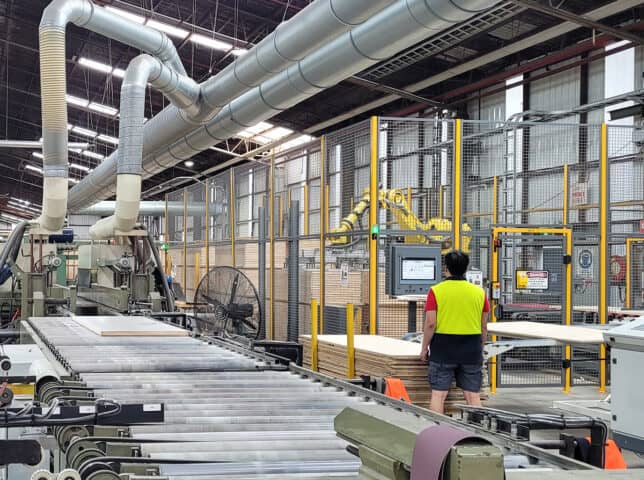 Man in manufacturing facility showing dust extraction infrastructure