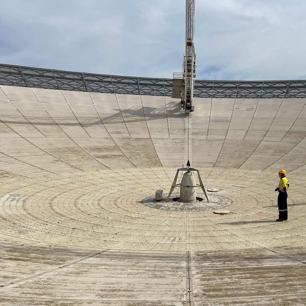 Female engineer inspecting the Parkes Telescope, Australia