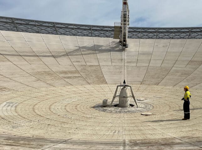 Female engineer inspecting the Parkes Telescope, Australia