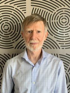 Photo of Brian in front of patterned background