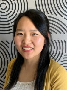 Photo of Rong in front of patterned background