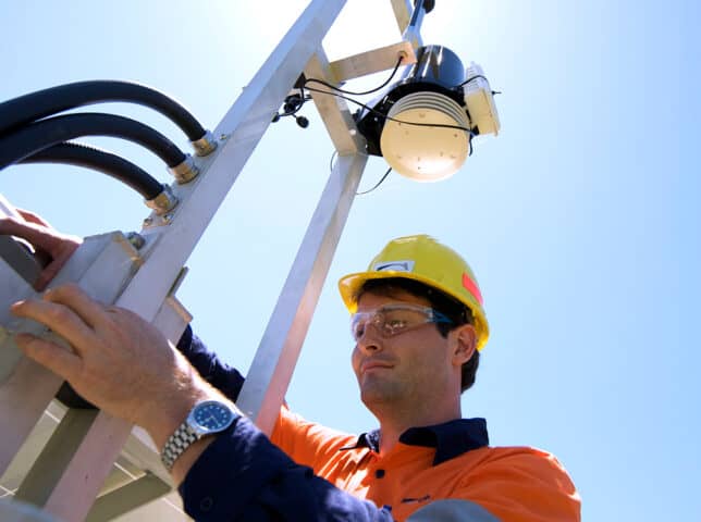 Man with environmental monitoring equipment in the field