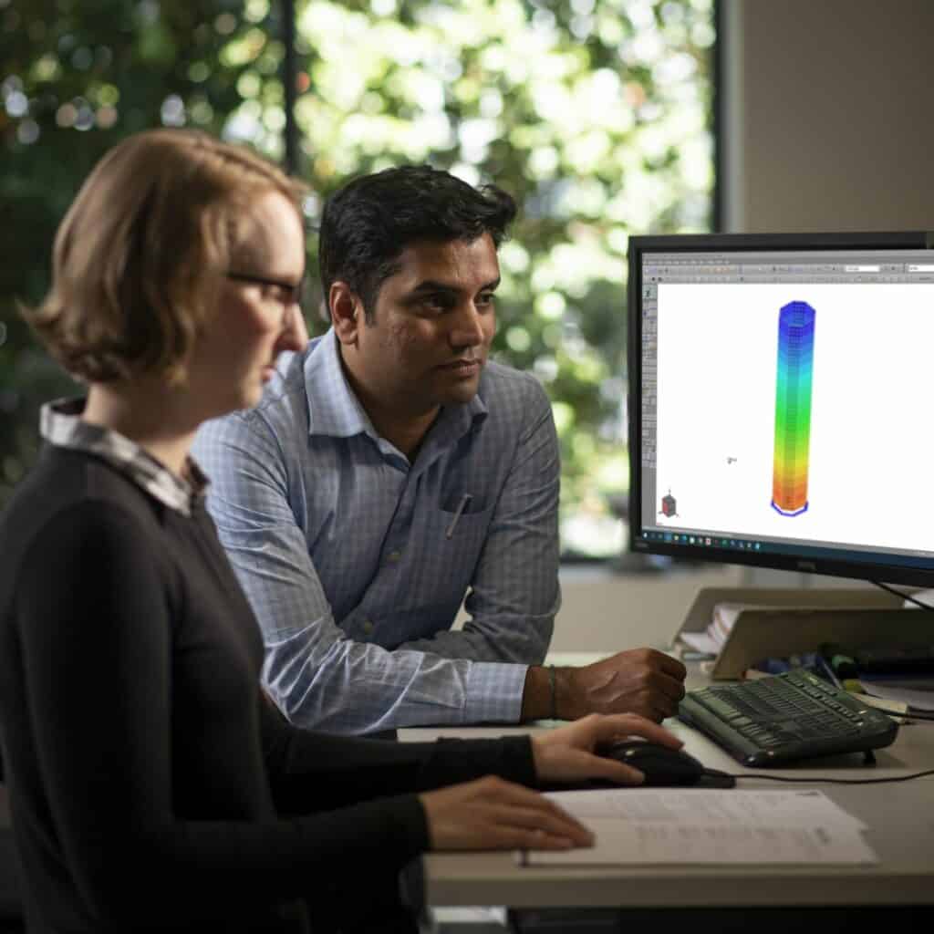 Lily and Ramesh in front of a computer.