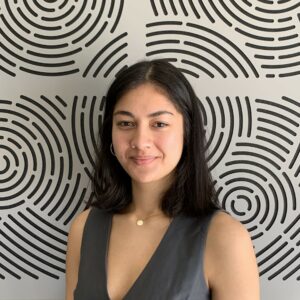Headshot of Luka in front of patterned background 