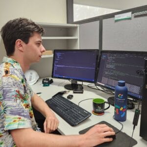 Toby sitting at a computer working 