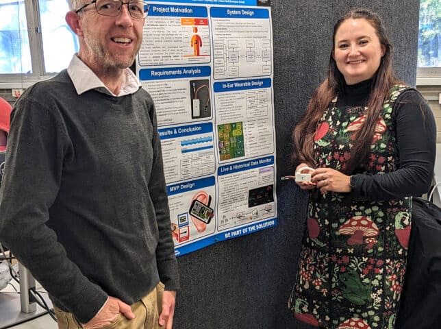 Simon Bull and Mikyla Peters in front of Mikyla's project poster